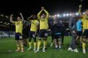 Oxford United players celebrate at full-time in midweek