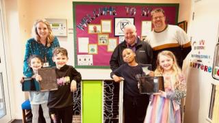 Pupils Sophie, Ethan, Grace, and Oscar with headteacher Michelle Rooke, Ray Collins, and Charlie Ellis