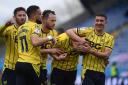 Oxford United players celebrate their fourth goal against Fleetwood Town