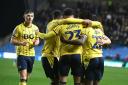 Oxford United players celebrate against Wigan Athletic back in February