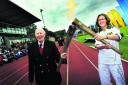 Sir Roger exchanges the Olympic flame with Nicola Byrom Picture OX52912 : Ed Nix