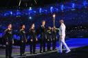 Oxford rower Cameron MacRitchie is handed the torch by Sir Steve Redgrave