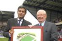 Firoz Kassam (left), Oxford United’s chairman in 2002, presents Jack Casley with a painting of the old Manor Ground to mark his services to the club