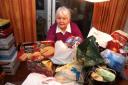 PILE OF PRESENTS: Marilyn Dyer-Lynch with some of the donated gifts