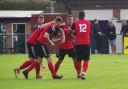 North Leigh captain Ben Brown is swamped after making it 2-0 in his side’s impressive win on SaturdayPicture: Edward Martin