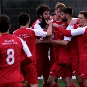 Didcot Town’s Cameron McNeill is mobbed by teammates after opening the scoring against Wantage Town this season. The Railwaymen now have big concerns about their future 	         Picture: Ric Mellis