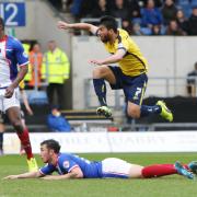 Oxford United midfielder Danny Rose is airborne as he fires in a shot which hits the underside of the bar and bounces clear to safety
