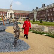 A Chelsea Pensioner walking past a young Bill Pendell MM. Picture by David Bingley