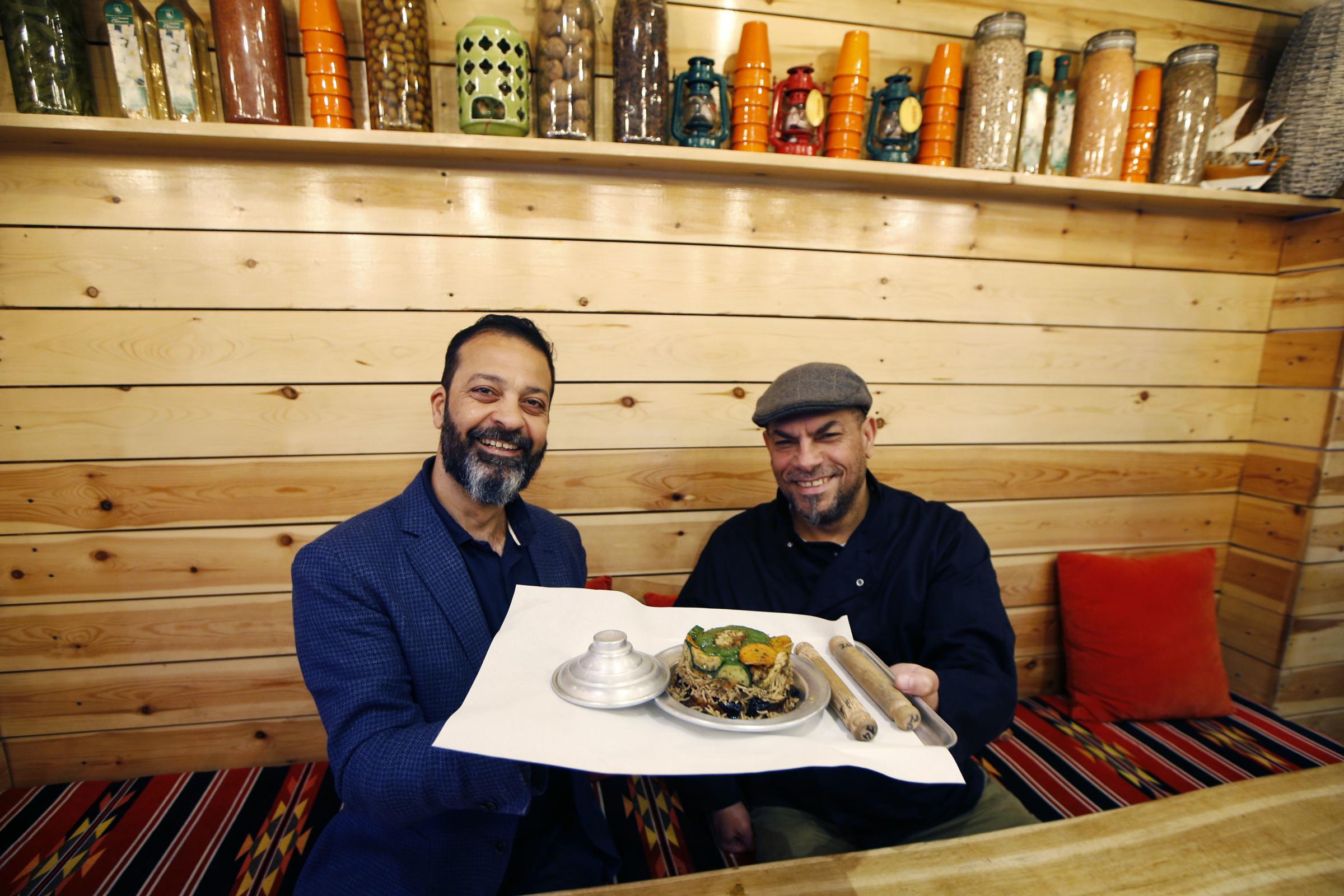Mahmoud Al-Hadad and Ahmad Mohamad serve up a dish at Zaatar Bake Picture: Ed Nix