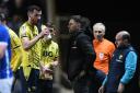 Oxford United boss Des Buckingham talks to skipper Elliott Moore during the reverse clash