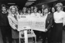 The Duchess of Marlborough, left, receives the cheque from Angela Barney and Alan Winterbourne