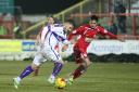 Alex MacDonald tries to force a way through the Accrington defence, but all in vain
