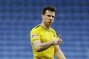 Johnny Mullins hobbled off in Oxford United’s draw at Cambridge United on Monday with a hip injury