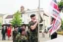 Private Barry Judd raises the flag in Abingdon Market Place