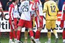 United defender Damien Batt is shown the red card