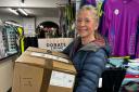 Nina Sarpong of Runwize Sports, Wallingford with the store's 12th collection box full of trainers to be donated to the JogOn initiative