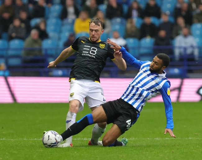 Sam Long is tackled against Sheffield Wednesday. Picture: Richard Parkes