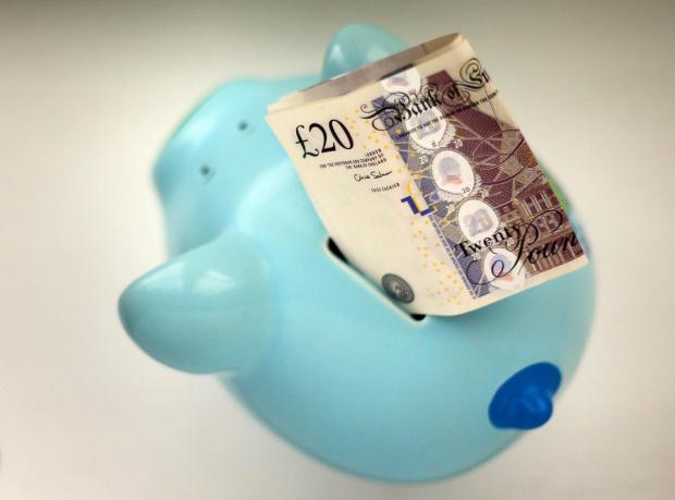 Herald Series: Piggy bank with a £20 note. Credit: PA