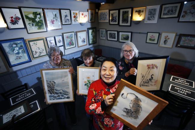 Art exhibition inside the Artyard Cafe in Enstone featuring Margaret White's work, a woman from Abingdon who set up the Tranquil Brush Group to paint Chinese style art.
L-R: Ann Applegate, Serena Marner, Jing Li and Jean Wykes.
Picture: Ed Nix.