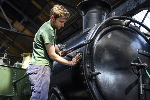 Herald Series: Ben cleaning one of the locomotives (Picture credit: Frank Dumbleton)