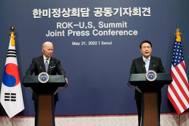 US President Joe Biden listens to South Korean President Yoon Suk Yeol speak during a news conference at the People’s House inside the Ministry of National Defence in Seoul
