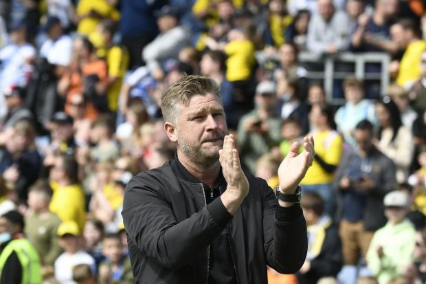Karl Robinson applauds the home supporters during the final match of the 2021/22 season, against Doncaster Rovers. Picture: David Fleming