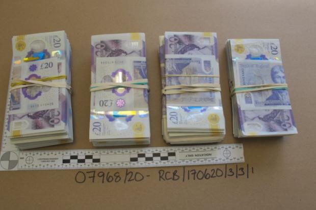 Herald Series: Some of the cash seized by detectives when they searched Joe Fisher's home Picture: TVP