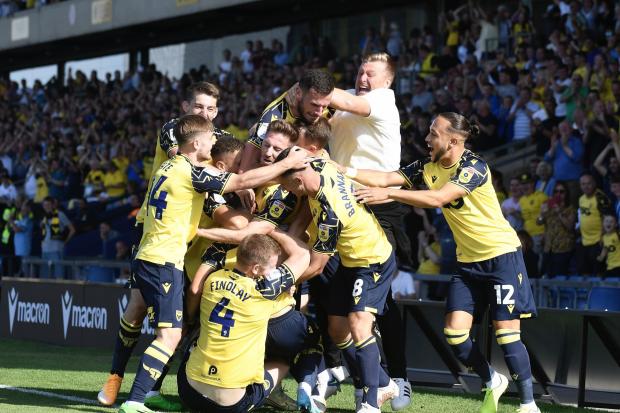 Karl Robinson celebrates with the Oxford United players after Tyler Goodrham's winner Picture: David Fleming