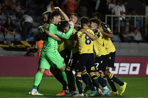 Ed McGinty celebrates with his Oxford United teammates after beating Swansea City on penalties Picture: David Fleming