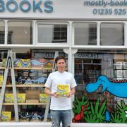 Rob Jones outside Mostly Books, Abingdon, holding his third children's book