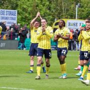 Oxford United players applaud the away support at Exeter City