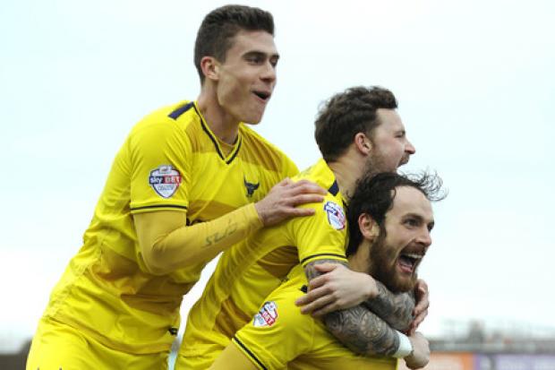 Danny Hylton, pictured celebrating a goal at AFC Wimbledon in February with fellow out-of-contract players Chris Maguire and Josh Ruffels, is one of nine Oxford United players who will find out their fate this week