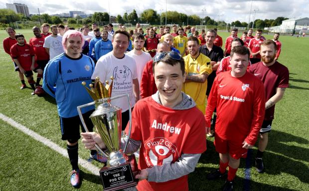 Herald Series: Andy Baker holding his Play2Give trophy that will be given to the winning team of his annual charity football tournament